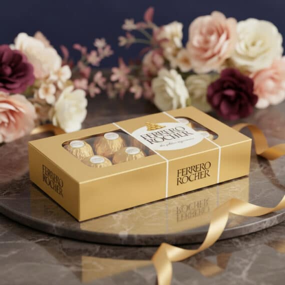 Caja de Chocolates Ferrero Rocher con Flores para Regalo Especial Caja de 8 chocolates Ferrero Rocher dorados sobre una bandeja de mármol con un lazo dorado y un arreglo floral elegante de fo